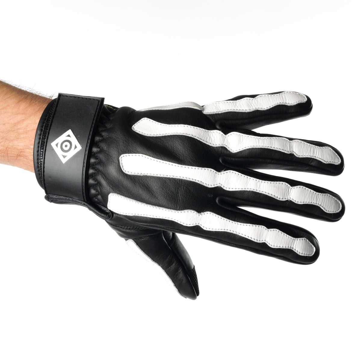 ONSRA BONES KEVLAR motorcycle gloves with white skeleton design and Kevlar reinforcement worn by a rider in a black shirt.