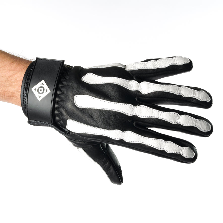 ONSRA BONES KEVLAR motorcycle gloves with white skeleton design and Kevlar reinforcement worn by a rider in a black shirt.