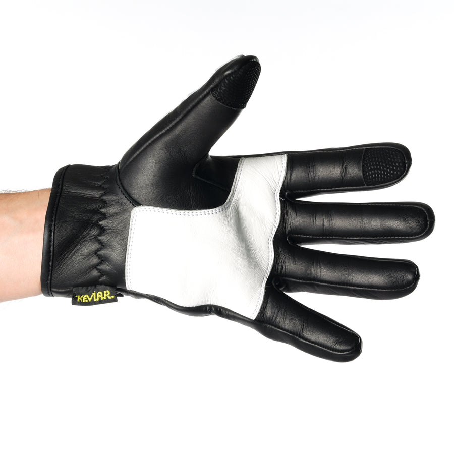 ONSRA BONES KEVLAR motorcycle gloves with white skeleton design and Kevlar reinforcement worn by a rider in a black shirt.