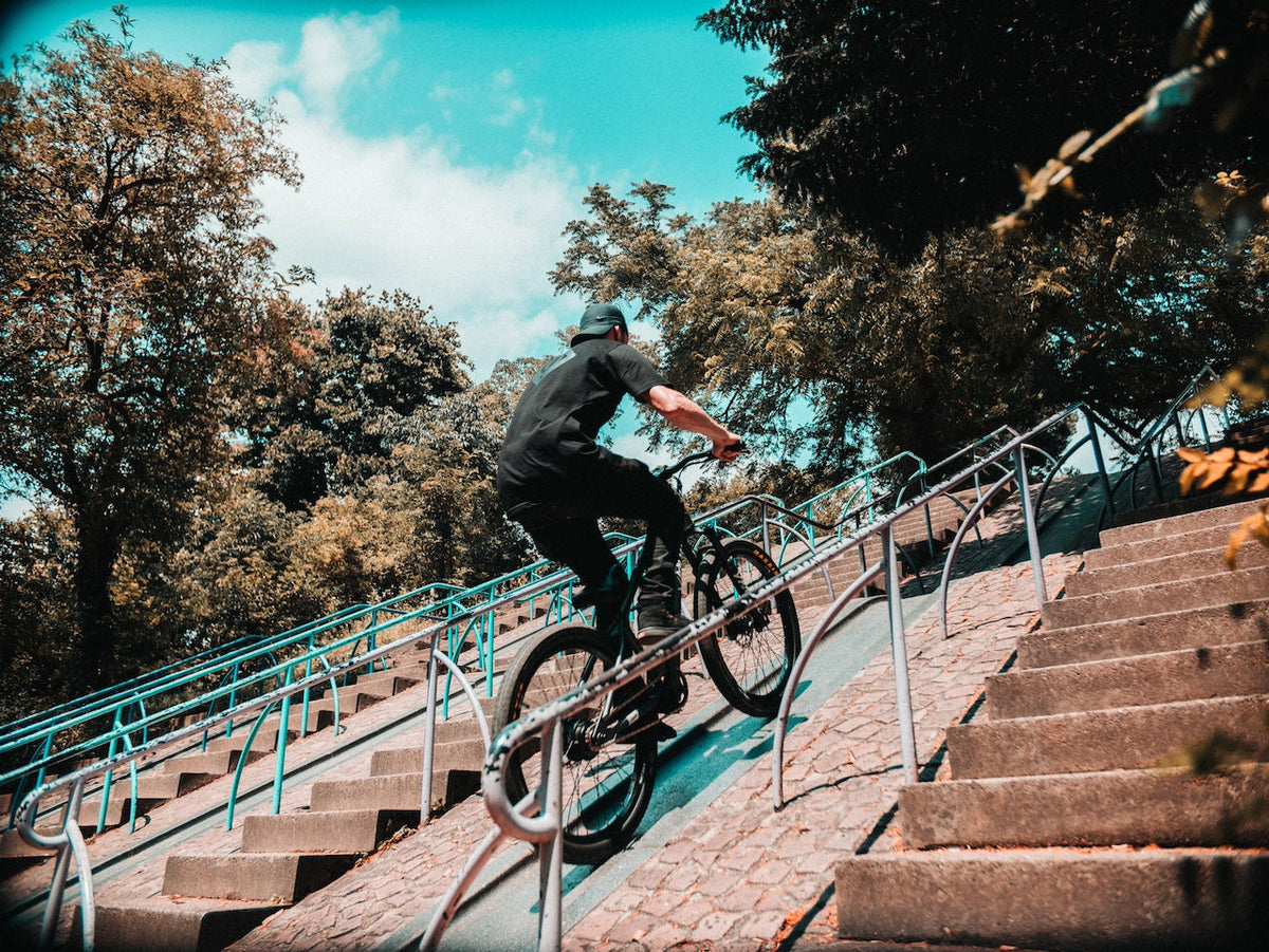 Rider on an ONSRA VANDAL electric bike riding down stairs